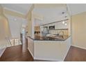 Modern kitchen with granite countertops, stainless steel appliances, and pendant lighting at 5601 Bentgrass Dr # 10-115, Sarasota, FL 34235