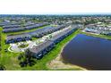Aerial view of townhomes in a lakeside community with lush landscaping and tranquil water features at 5734 Archipelago St, Nokomis, FL 34275