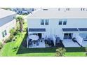 Backyard patio features outdoor seating, lush green space, and privacy in a townhome community at 5734 Archipelago St, Nokomis, FL 34275
