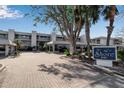 Condominium exterior showing complex entrance, signage, and manicured landscaping at 5757 Gulf Of Mexico Dr # 110, Longboat Key, FL 34228