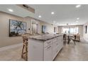 Kitchen with island and stool seating overlooks an open living space at 5757 Gulf Of Mexico Dr # 110, Longboat Key, FL 34228