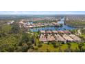 Panoramic aerial view of a serene community, nestled around picturesque lakes and lush greenery at 7623 Camminare Dr, Sarasota, FL 34238