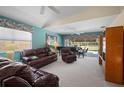 Comfortable living room with plush leather seating, neutral carpet, and a grand piano at 7623 Camminare Dr, Sarasota, FL 34238