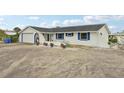 Charming single-story home with a two-car garage, neutral paint scheme, and potted plants along the front of the house at 928 Spindle Palm Way, Apollo Beach, FL 33572