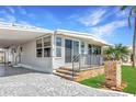 Charming single-story home with a covered parking area, brick accents, and a well-maintained lawn at 10315 Cortez W Rd # 38Bv, Bradenton, FL 34210
