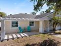 Charming porch area with bright blue chairs and a small table, perfect for enjoying the outdoors at 106 N Blvd Of The Presidents, Sarasota, FL 34236