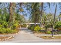 Charming home with lush landscaping, a carport, and a welcoming driveway at 109 Burney Rd, Osprey, FL 34229