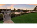 Waterfront property featuring a private boat dock, green lawn, and tranquil canal views at 11739 River Shores Trl, Parrish, FL 34219