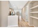 Open-concept floor plan with modern finishes, wood-look tile flooring, and a view of the staircase at 11831 Brookside Dr, Bradenton, FL 34211