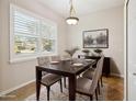 Inviting dining room featuring hardwood floors, large window, and elegant decor, ideal for Gathering meals at 14150 Cattle Egret Pl, Lakewood Ranch, FL 34202