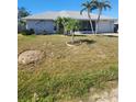 Inviting single-story home with well-manicured lawn and palm trees, enhanced by dolphin art at 1472 Nantucket Rd, Venice, FL 34293