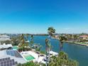 Beautiful aerial view of a waterfront property featuring a private dock, pool, and solar panels at 148 N Polk, Sarasota, FL 34236