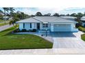 Well-maintained single-story home with an attached garage, manicured lawn, and complemented by a white picket fence at 1511 S Knollwood Dr, Bradenton, FL 34208