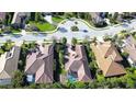 An aerial view shows the home's layout, surrounded by manicured lawns and mature trees at 15403 Leven Links Pl, Lakewood Ranch, FL 34202