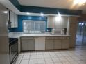 Well-lit kitchen with stainless steel appliances and a sliding door to the outdoor area at 1717 Alton Rd, Port Charlotte, FL 33952