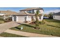 Beautiful two-story home with manicured lawn and a three-car garage at 17703 Savory Mist Cir, Bradenton, FL 34211