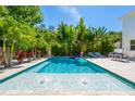 Inviting backyard pool surrounded by lush tropical landscaping, offering a serene and private oasis at 2283 Arlington St, Sarasota, FL 34239