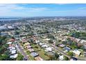 Wide aerial shot displays the neighborhood layout with lush greenery and a clear view of the surrounding landscape at 2434 Carlisle Pl, Sarasota, FL 34231