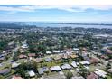 Expansive aerial view showcases the neighborhood, highlighting proximity to water and urban amenities in the distance at 2434 Carlisle Pl, Sarasota, FL 34231