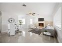 Bright living room featuring a fireplace, modern decor, and sleek tile flooring, great for entertaining at 317 Harbor S Dr, Venice, FL 34285