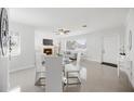Bright living room with large windows, fireplace, open concept, and modern tile flooring, perfect gathering area at 317 Harbor S Dr, Venice, FL 34285