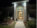 Inviting front entrance with glass door and sidelights, offering a glimpse of the well-lit interior at 3650 S Sumter Blvd, North Port, FL 34287
