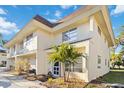 Two-story condo featuring lush landscaping with rock features and a young palm at 3721 Delta St # 93, Sarasota, FL 34232
