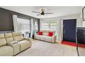 Cozy living room with plush furnishings, lots of natural light, and a ceiling fan at 3721 Delta St # 93, Sarasota, FL 34232