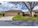 Charming home featuring a tile roof, well-manicured lawn, and a two-car garage at 3933 Glen Oaks Manor Dr, Sarasota, FL 34232