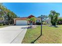 Charming home features a well-kept lawn and a two-car garage, perfect curb appeal at 5103 73Rd E St, Bradenton, FL 34203