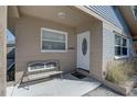 Inviting front porch with a comfortable bench, a white door, and detailed trim enhancing curb appeal at 511 74Th N Ave, St Petersburg, FL 33702