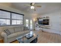 Bright living room with a ceiling fan, large window, modern furniture, and a glass coffee table at 511 74Th N Ave, St Petersburg, FL 33702