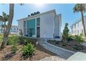 Charming condo exterior with well-kept landscaping and a paved walkway leading to the entrance at 5400 Gulf Dr # 35, Holmes Beach, FL 34217