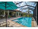 Enclosed pool area with a large pool and an outdoor seating area, perfect for relaxing at 5656 Cantucci St, Nokomis, FL 34275