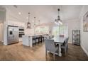 Open concept kitchen with stainless steel appliances, a large island, and an adjacent dining area for entertaining at 5708 Holmes Blvd, Holmes Beach, FL 34217