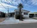 Inviting single-story home with a driveway and carport, featuring a well-kept lawn and landscaping at 618 51St W Ave, Bradenton, FL 34207