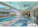 Inviting screened-in patio with comfortable seating, ceiling fan, and views of the sparkling pool at 6684 Easton Dr, Sarasota, FL 34238