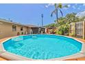 Inviting backyard with a sparkling in-ground pool, perfect for relaxing and entertaining on sunny days at 1011 68Th W Ave, Bradenton, FL 34207