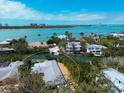 Beautiful aerial view of the home with backyard pool and dock, located on a waterfront property with city views at 110 Faubel St, Sarasota, FL 34242