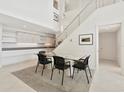 Bright dining area with glass table, modern chairs, and a view of the contemporary kitchen at 1990 Main St # 10, Sarasota, FL 34236