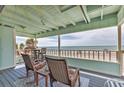 Relax on this covered porch featuring calming ocean views and comfortable seating at 2350 N Beach Rd # 1A, Englewood, FL 34223