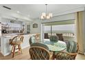 Bright dining area with a round glass table, beach views, and bar seating at 2350 N Beach Rd # 1A, Englewood, FL 34223
