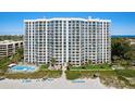 Luxury high-rise beachfront condo with pristine white sand and inviting outdoor pool at 2425 Gulf Of Mexico Dr # 3E, Longboat Key, FL 34228