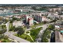Community aerial view, featuring condos, pool, green spaces, and waterfront access at 244 Saint Augustine Ave # 905, Venice, FL 34285