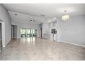 Bright and airy open-concept living space with tile floors, recessed lighting, and access to the backyard at 25259 Alcazar Dr, Punta Gorda, FL 33955