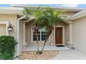 Close-up of the front door, framed by columns and small palm trees at 3189 Seattle Ave, North Port, FL 34286