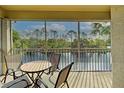 Relaxing screened lanai with seating and a view of the serene lake and lush greenery at 403 Auburn Lakes Cir # 403, Venice, FL 34292