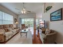 Bright living room featuring hardwood floors, ceiling fan, and sliding doors to the lanai at 403 Auburn Lakes Cir # 403, Venice, FL 34292