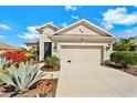 Beautifully landscaped home with an attached two-car garage and lush plantings at 4439 29Th Avenue E Cir, Palmetto, FL 34221