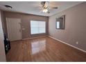 Inviting living room with beautiful wood floors, ceiling fan, and natural light from window at 4506 Runabout Way, Bradenton, FL 34203